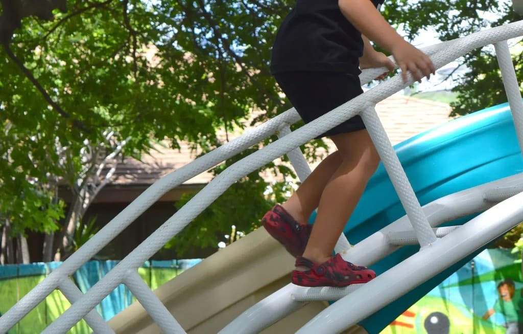 Child climbing the playground slide